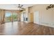 Serene main bedroom with wood floors, a ceiling fan, access to a balcony, and en-suite bathroom entry at 3370 E Flamingo Ct, Gilbert, AZ 85297