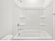 Bathroom showcasing a bathtub-shower combination with all white enclosure and silver fixtures at 37084 W Prado St, Maricopa, AZ 85138