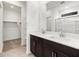 Bathroom featuring a double sink vanity and a walk-in shower with closet at 37084 W Prado St, Maricopa, AZ 85138