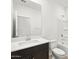 Well-lit bathroom featuring a dark wood vanity, white countertop, a toilet, and a shower with tub at 37084 W Prado St, Maricopa, AZ 85138