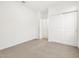 Bright bedroom with neutral carpet and closet sliding doors at 37084 W Prado St, Maricopa, AZ 85138