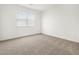 Neutral bedroom featuring a large window providing natural light at 37084 W Prado St, Maricopa, AZ 85138