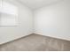 Carpeted bedroom featuring a large window allowing lots of natural light into the space at 37084 W Prado St, Maricopa, AZ 85138