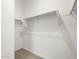 Bright, walk-in closet with carpeted flooring and simple hanging rod at 37084 W Prado St, Maricopa, AZ 85138