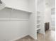 Walk-in closet features a closet rod and shelving, for storing clothes and personal items at 37084 W Prado St, Maricopa, AZ 85138