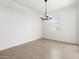 Bright dining room features tile floors, a modern chandelier and a large window at 37084 W Prado St, Maricopa, AZ 85138