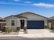 Charming one-story home showcasing a two-car garage, well-maintained landscape, and neutral tones at 37084 W Prado St, Maricopa, AZ 85138
