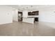 Open concept kitchen features an island with seating, granite countertops, and stainless steel appliances at 37084 W Prado St, Maricopa, AZ 85138