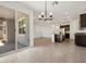 Open floor plan features the kitchen and living area with a sliding glass door to the patio at 37084 W Prado St, Maricopa, AZ 85138