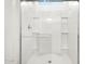 Bright white shower features glass doors, modern fixtures, and tile surround at 37084 W Prado St, Maricopa, AZ 85138