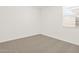 Bright bedroom featuring neutral carpet and natural light from the window at 37111 W Prado St, Maricopa, AZ 85138
