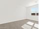 Well lit bedroom featuring neutral carpet and a window at 37111 W Prado St, Maricopa, AZ 85138