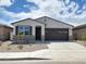 Charming single-story home featuring a two-car garage and low-maintenance desert landscaping at 37111 W Prado St, Maricopa, AZ 85138