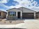 Charming single-story home featuring a two-car garage and low-maintenance desert landscaping at 37111 W Prado St, Maricopa, AZ 85138