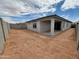 New construction backyard featuring a covered patio and cinder block wall at 37112 W Prado St, Maricopa, AZ 85138