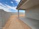 New construction backyard featuring a covered patio and cinder block wall at 37112 W Prado St, Maricopa, AZ 85138