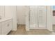 Bathroom featuring a walk-in shower with sliding glass doors, toilet, and a single sink vanity at 37112 W Prado St, Maricopa, AZ 85138
