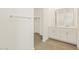 Bathroom with double sinks, tile flooring, and walk-in closet at 37112 W Prado St, Maricopa, AZ 85138