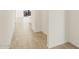Clean hallway with neutral tile floors and white walls, offering a minimalist aesthetic at 37112 W Prado St, Maricopa, AZ 85138