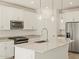 Close up shot of kitchen with white cabinets, stainless steel appliances, and center island at 37112 W Prado St, Maricopa, AZ 85138