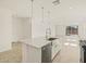 Kitchen island features modern pendant lighting, stainless dishwasher, and granite countertops at 37112 W Prado St, Maricopa, AZ 85138