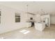 Open-concept kitchen with stainless appliances, granite countertops, large center island, and pendant lighting at 37112 W Prado St, Maricopa, AZ 85138