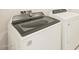 Close up shot of a new, white, front load washing machine next to a dryer at 37112 W Prado St, Maricopa, AZ 85138