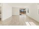 Open living space with neutral tile, large windows, and sliding glass door for seamless indoor-outdoor living at 37112 W Prado St, Maricopa, AZ 85138