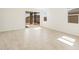 Bright, open living area with tiled floors, large windows, and sliding glass doors offering natural light at 37112 W Prado St, Maricopa, AZ 85138