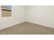 A bright room showcasing neutral carpeting and light at 37112 W Prado St, Maricopa, AZ 85138