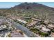 Expansive aerial view of a desert community with lush landscaping and stunning mountain views on a sunny day at 37300 N Tom Darlington Dr # D, Carefree, AZ 85377