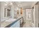 Well-lit bathroom features a dual sink vanity, decorative mirrors, and access to a tiled shower at 37300 N Tom Darlington Dr # D, Carefree, AZ 85377