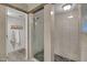 Bathroom featuring a tiled shower stall with a glass door and a separate dressing area at 37300 N Tom Darlington Dr # D, Carefree, AZ 85377