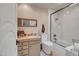 Neutral bathroom with a framed mirror and bathtub with glass door at 37300 N Tom Darlington Dr # D, Carefree, AZ 85377