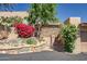 Attractive front entrance with stone accents, mature trees, and vibrant landscaping at 37300 N Tom Darlington Dr # D, Carefree, AZ 85377