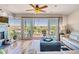 Living room with fireplace, ceiling fan and access to a large balcony with mountain views at 37300 N Tom Darlington Dr # D, Carefree, AZ 85377