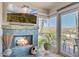 Inviting living room features a stone fireplace and a large TV with stunning desert landscape views at 37300 N Tom Darlington Dr # D, Carefree, AZ 85377
