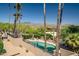 Inviting pool and patio area surrounded by lush desert landscape with great views at 37300 N Tom Darlington Dr # D, Carefree, AZ 85377