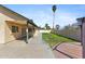 Backyard patio features a spacious covered area, concrete walkway, and a well-maintained lawn at 4007 W Thunderbird Rd, Phoenix, AZ 85053