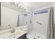 Clean bathroom features a shower, vanity, updated fixtures and striped shower curtain at 4007 W Thunderbird Rd, Phoenix, AZ 85053