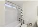 Bathroom featuring a tub with white tile surround and shower at 4007 W Thunderbird Rd, Phoenix, AZ 85053