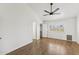 Bright bedroom featuring wood floors, ceiling fan, and white walls at 4007 W Thunderbird Rd, Phoenix, AZ 85053