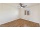 Bedroom featuring wood floors, ceiling fan, and window with plantation shutters at 4007 W Thunderbird Rd, Phoenix, AZ 85053