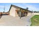 Exterior of home features a covered patio, tan stucco and lush grass at 4007 W Thunderbird Rd, Phoenix, AZ 85053
