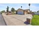 Exterior view of a house with a large driveway, two-car garage, and brick accents at 4007 W Thunderbird Rd, Phoenix, AZ 85053