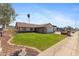 Charming home featuring a well-manicured lawn, brick accents, and a welcoming facade at 4007 W Thunderbird Rd, Phoenix, AZ 85053