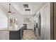 Bright kitchen features stainless steel appliances, tile flooring, and island with cooktop and seating at 4007 W Thunderbird Rd, Phoenix, AZ 85053