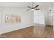 Bright living room featuring hardwood flooring, modern lighting, and a view to the rest of the house at 4007 W Thunderbird Rd, Phoenix, AZ 85053