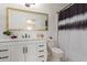 Bathroom featuring white vanity and framed mirror at 4232 N 112Th Ln, Phoenix, AZ 85037