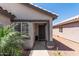 Inviting front porch with a decorative security door and lush tropical plants at 4232 N 112Th Ln, Phoenix, AZ 85037